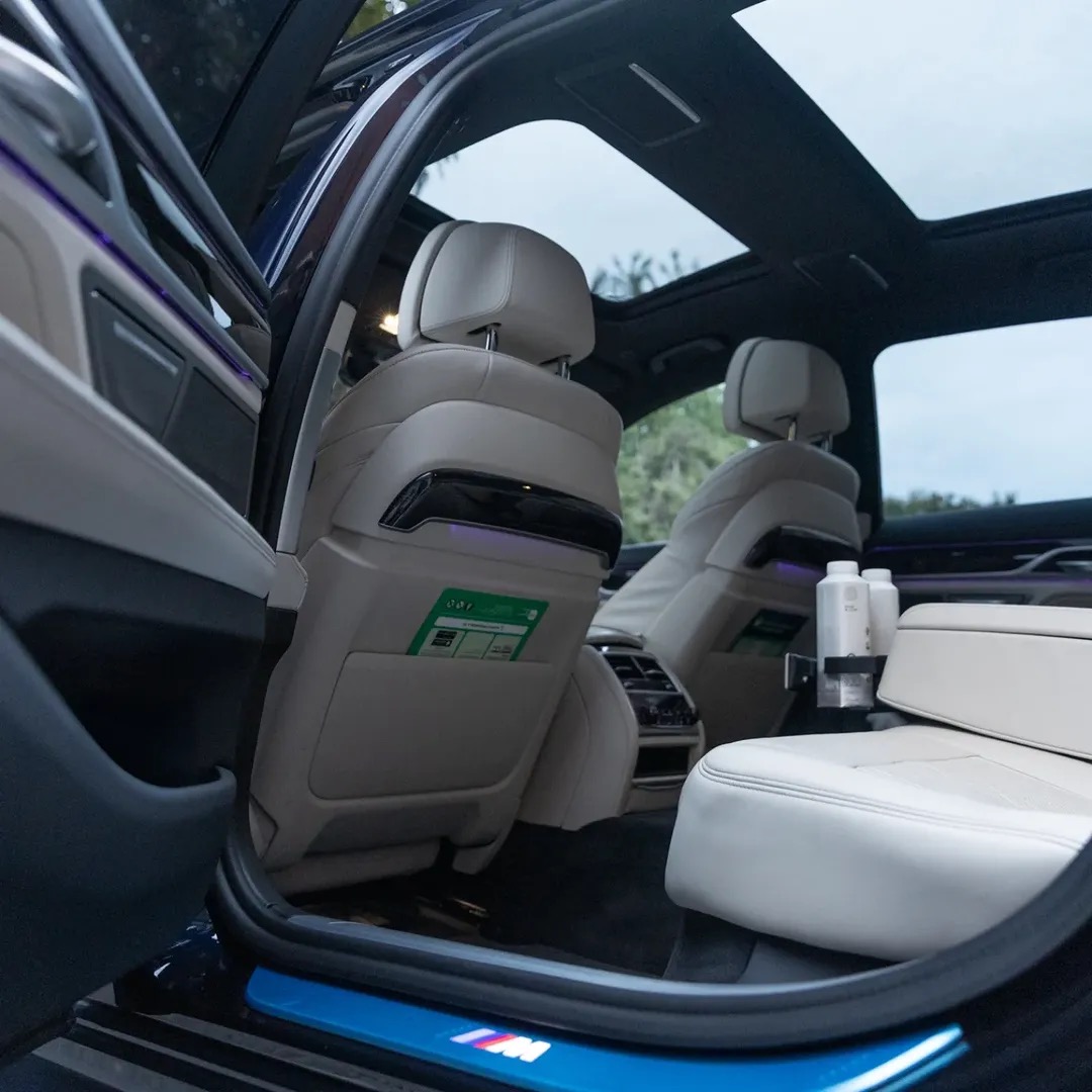 Rear cabin of the BMW 745Le with ivory leather seats and panoramic roof